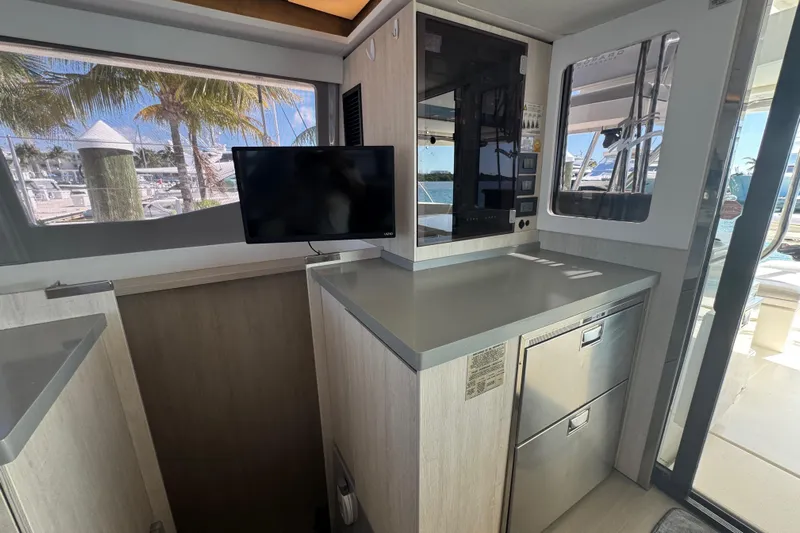 Ce Ya Yacht Photos Pics Interior of a 2021 Leopard 45 yacht with modern kitchen and TV.
