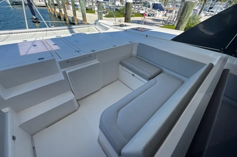 Ce Ya Yacht Photos Pics 2021 Leopard 45 yacht cockpit with gray seating and storage, docked at marina.