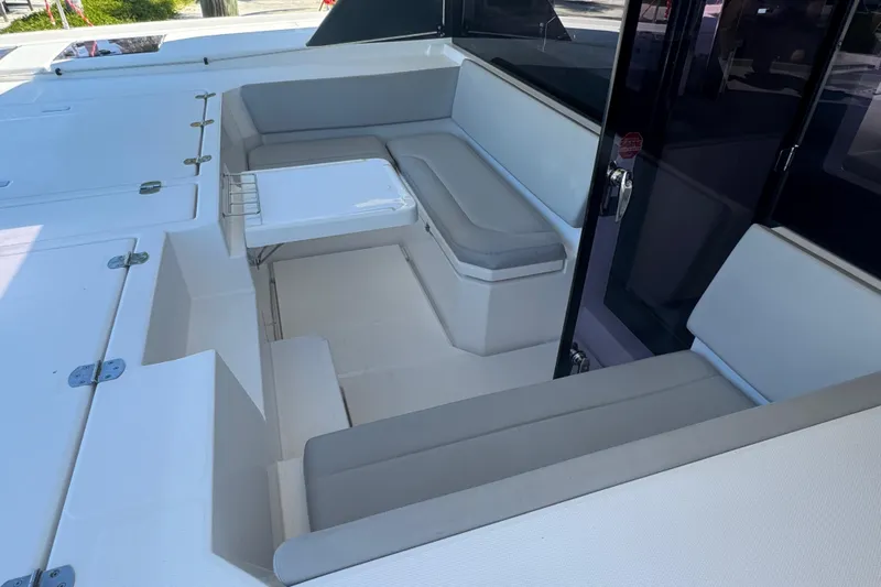 Ce Ya Yacht Photos Pics 2021 Leopard 45 yacht interior with cushioned seating and table.