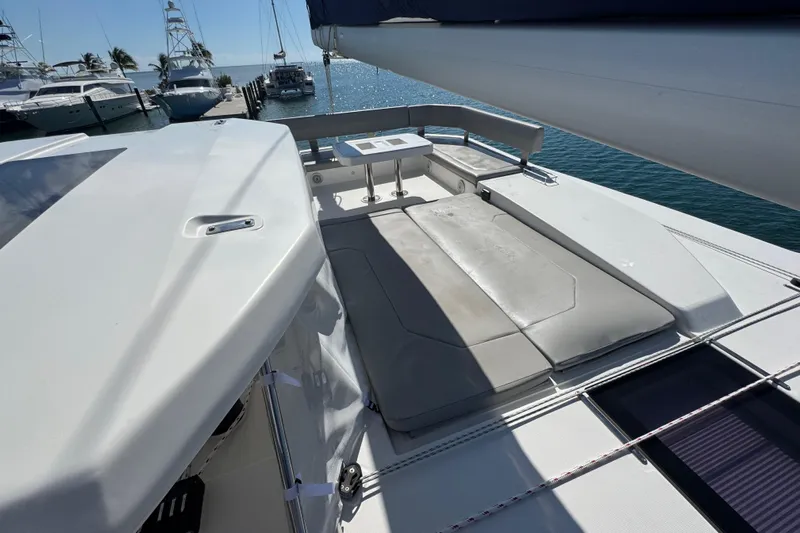 Ce Ya Yacht Photos Pics 2021 Leopard 45 yacht deck with sunbathing area, docked at marina.