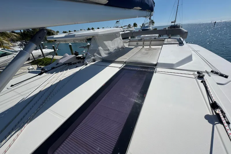 Ce Ya Yacht Photos Pics 2021 Leopard 45 catamaran deck with solar panel, docked by the sea.