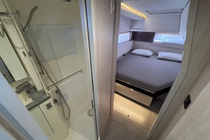 Ce Ya Yacht Photos Pics Modern interior of 2021 Leopard 45 yacht featuring a cozy bedroom and compact bathroom.