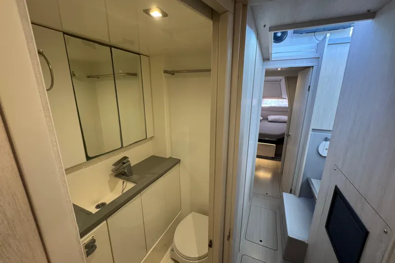 Ce Ya Yacht Photos Pics Modern bathroom and hallway in 2021 Leopard 45 yacht, featuring sleek design and ample lighting.
