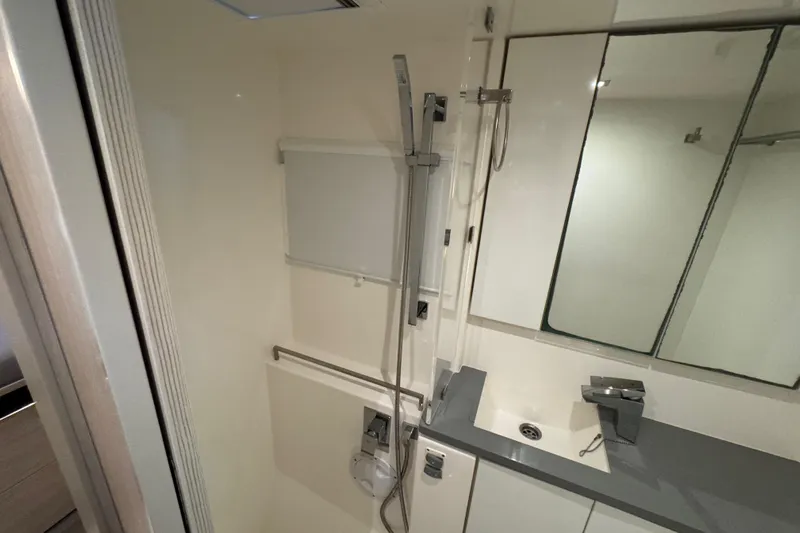 Ce Ya Yacht Photos Pics Modern bathroom interior in a 2021 Leopard 45 yacht, featuring sleek fixtures and a mirrored cabinet.