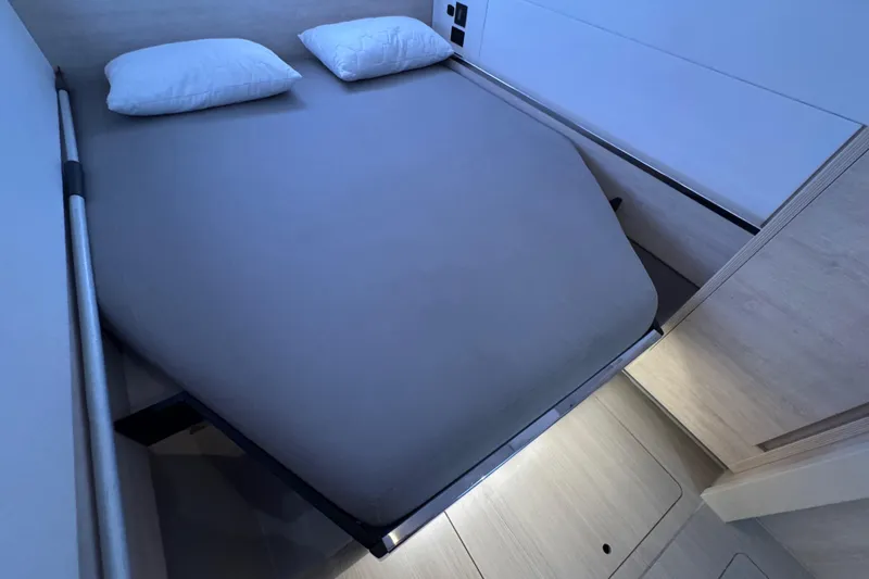 Ce Ya Yacht Photos Pics Modern bedroom interior on 2021 Leopard 45 yacht, featuring a neatly made bed.