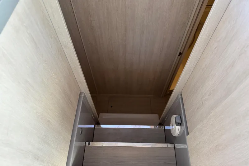 Ce Ya Yacht Photos Pics Staircase inside 2021 Leopard 45 yacht with wooden paneling.