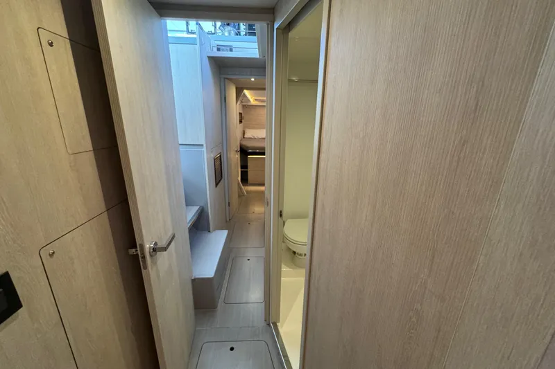 Ce Ya Yacht Photos Pics Interior of 2021 Leopard 45 yacht showing hallway, bathroom, and cabin.