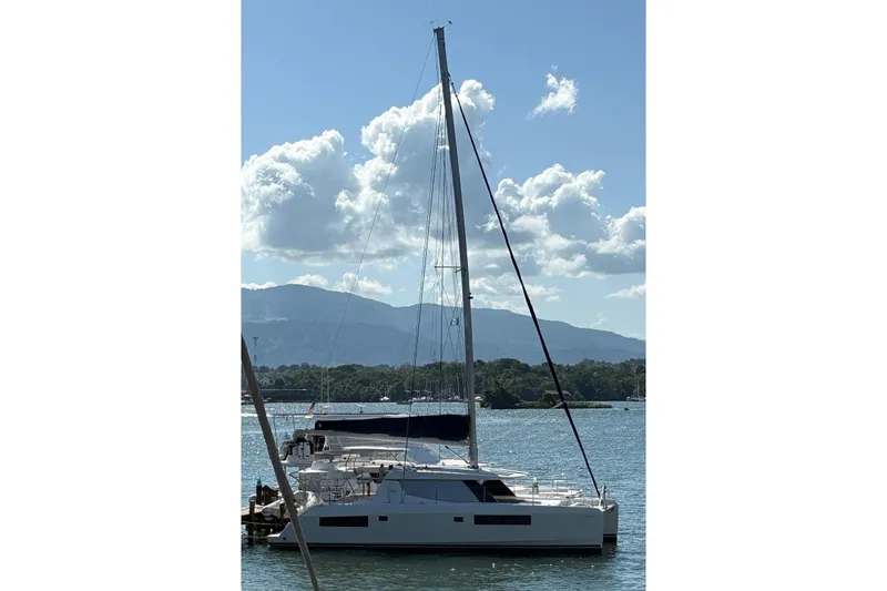 Ce Ya Yacht Photos Pics 2021 Leopard 45 catamaran docked on a sunny day with mountains in the background.