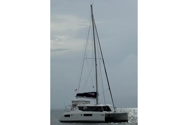 Ce Ya Yacht Photos Pics 2021 Leopard 45 catamaran sailing on calm waters under a cloudy sky.