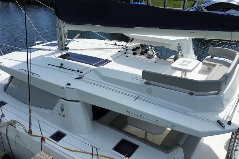 Ce Ya Yacht Photos Pics 2021 Leopard 45 catamaran with spacious deck and seating area, docked at marina.