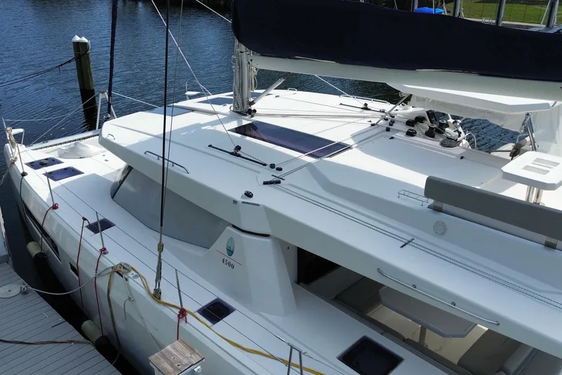 Ce Ya Yacht Photos Pics 2021 Leopard 45 catamaran docked at marina, showcasing sleek design and spacious deck.