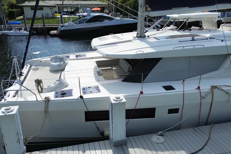 Ce Ya Yacht Photos Pics 2021 Leopard 45 catamaran docked at marina, showcasing sleek design and spacious deck.