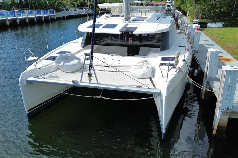 Ce Ya Yacht Photos Pics 2021 Leopard 45 catamaran docked in a serene marina setting.