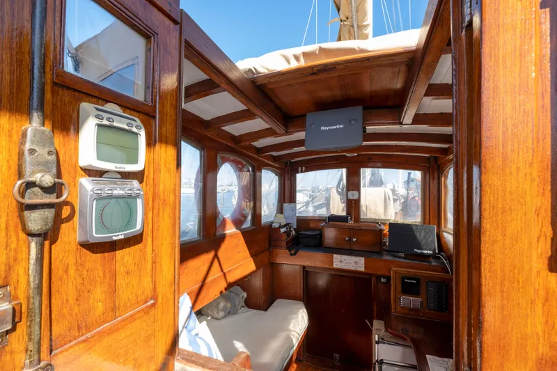 Juliette Yacht Photos Pics Interior of 1929 Custom Cutter Marconi sailboat with wooden finish and navigation equipment.