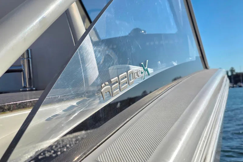  Yacht Photos Pics Close-up of 2018 World Cat 280 DC-X boat logo with water in background.