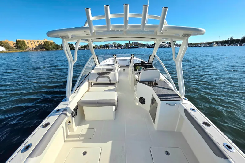  Yacht Photos Pics 2018 World Cat 280 DC-X boat on calm water, showcasing spacious deck and seating.