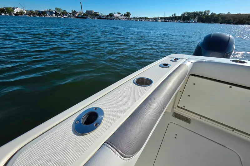  Yacht Photos Pics 2018 World Cat 280 DC-X boat on calm water, featuring sleek design and cup holders.