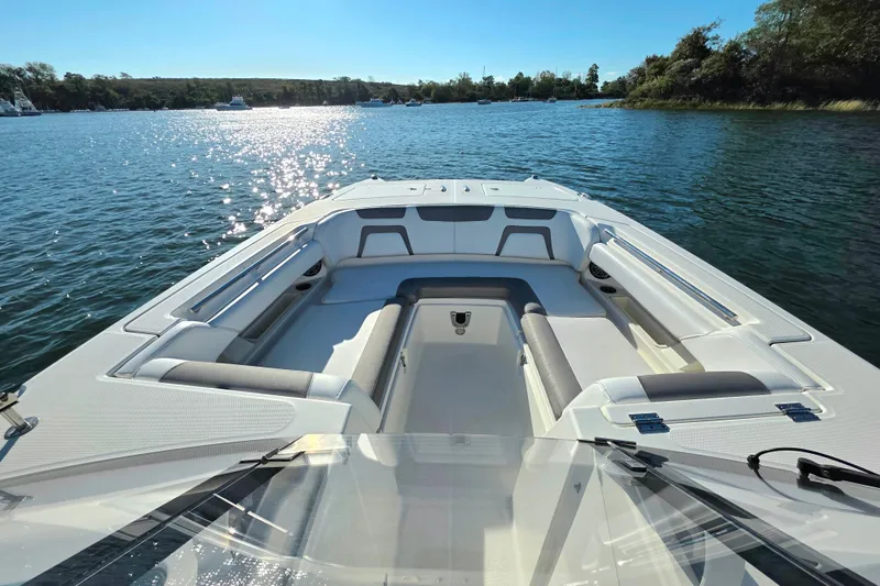  Yacht Photos Pics 2018 World Cat 280 DC-X boat on serene water, featuring spacious seating and clear skies.