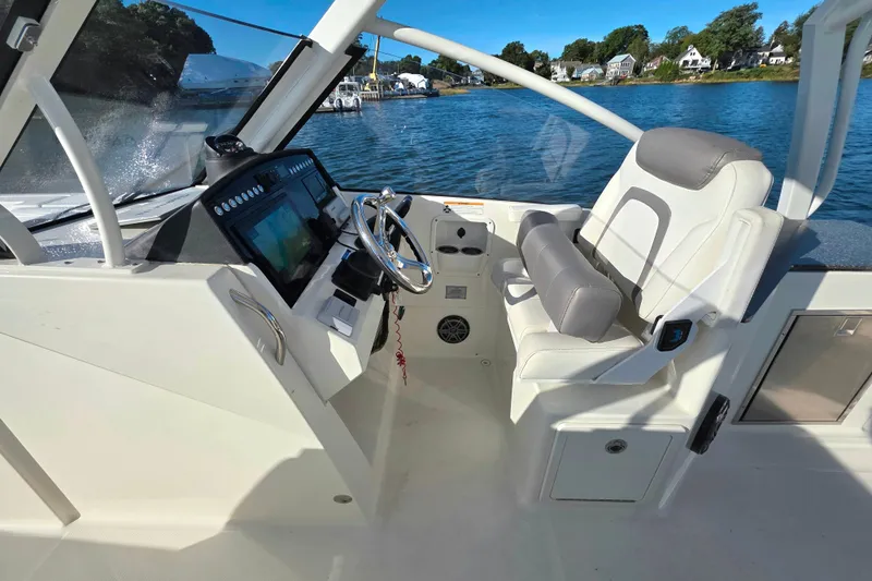  Yacht Photos Pics 2018 World Cat 280 DC-X boat cockpit with steering wheel and comfortable seating.