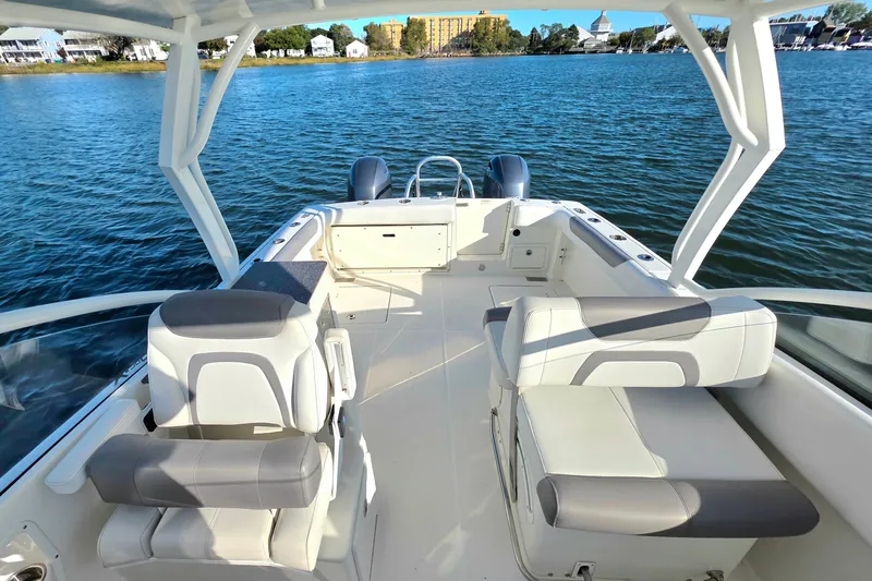  Yacht Photos Pics 2018 World Cat 280 DC-X boat interior with seating, on calm water.