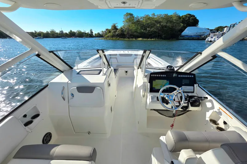  Yacht Photos Pics 2018 World Cat 280 DC-X boat interior with steering wheel and navigation system.