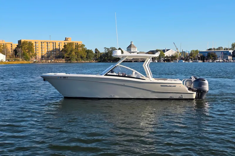  Yacht Photos Pics 2018 World Cat 280 DC-X boat on calm water with cityscape background.