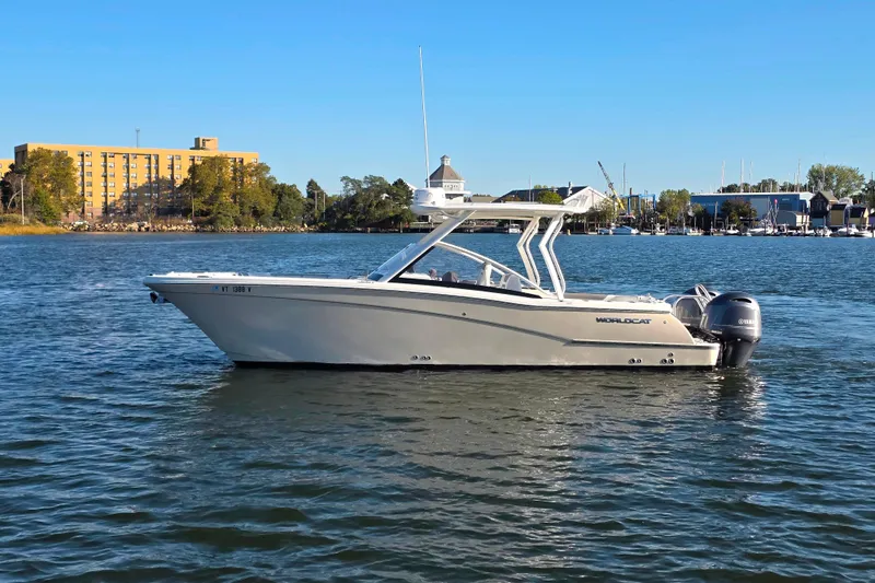  Yacht Photos Pics 2018 World Cat 280 DC-X boat on calm water, cityscape background.