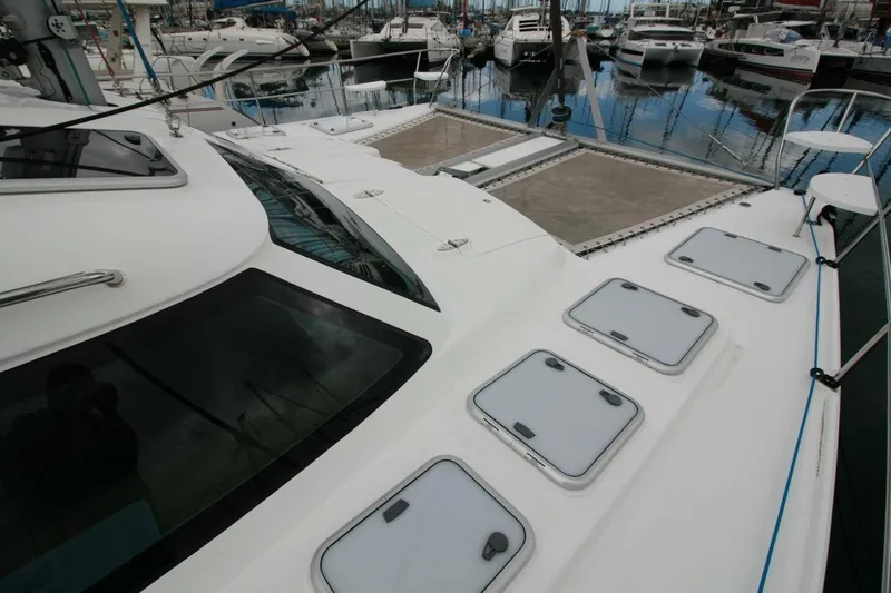 Laminic Yacht Photos Pics 2022 Maverick Yachts 440 Custom catamaran docked in marina, showcasing sleek deck design.