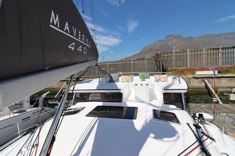 Laminic Yacht Photos Pics 2022 Maverick Yachts 440 Custom sailboat docked with mountain backdrop.