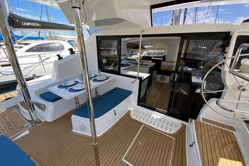 Laminic Yacht Photos Pics 2022 Maverick Yachts 440 Custom interior with dining area and helm, docked at marina.