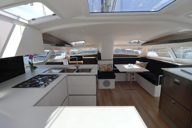 Laminic Yacht Photos Pics Luxurious interior of 2022 Maverick Yachts 440 Custom, featuring modern kitchen and dining area.