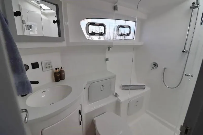 Laminic Yacht Photos Pics Modern bathroom in 2022 Maverick Yachts 440 Custom, featuring sleek fixtures and ample natural light.