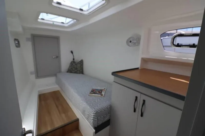 Laminic Yacht Photos Pics Cozy cabin interior of 2022 Maverick Yachts 440 Custom with bed, skylights, and storage.