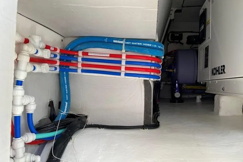 Laminic Yacht Photos Pics Engine room of 2022 Maverick Yachts 440 Custom with visible plumbing and Kohler equipment.