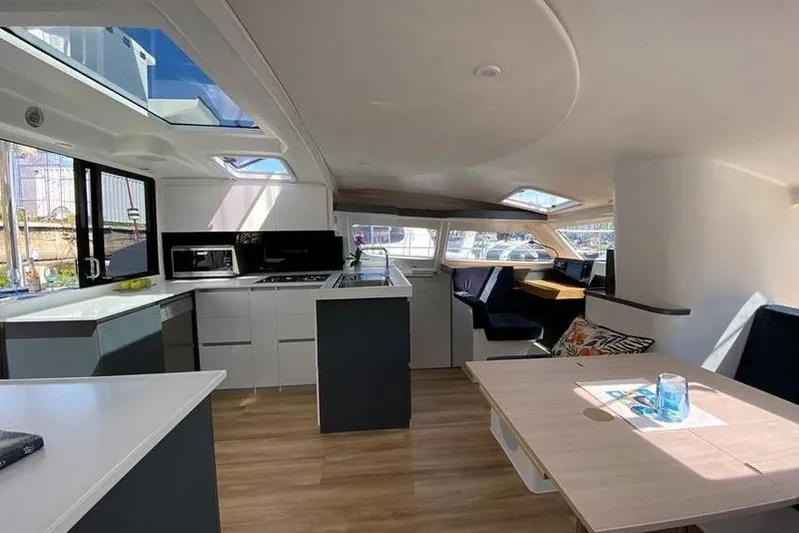 Laminic Yacht Photos Pics Modern interior of 2022 Maverick Yachts 440 Custom, featuring sleek kitchen and dining area.