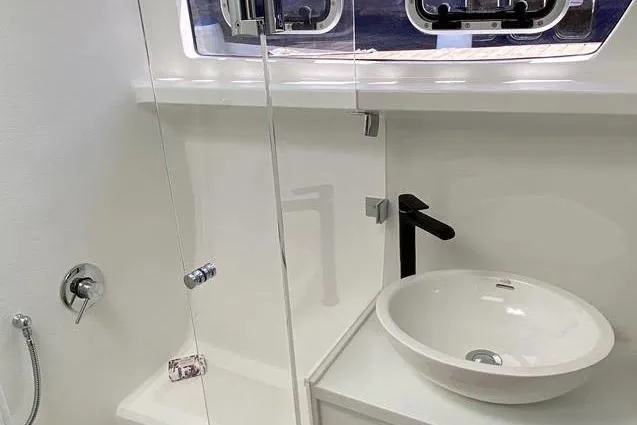Laminic Yacht Photos Pics Modern bathroom in 2022 Maverick Yachts 440 Custom, featuring sleek sink and glass shower.