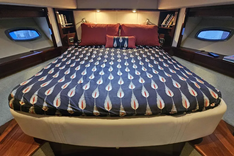  Yacht Photos Pics Luxurious bedroom interior of 2007 Sea Ray 60 Sundancer yacht with patterned bedding.
