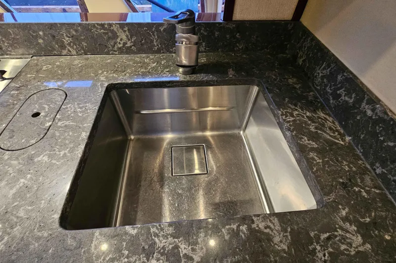  Yacht Photos Pics Stainless steel sink on Sea Ray 60 Sundancer 2007 yacht with marble countertop.