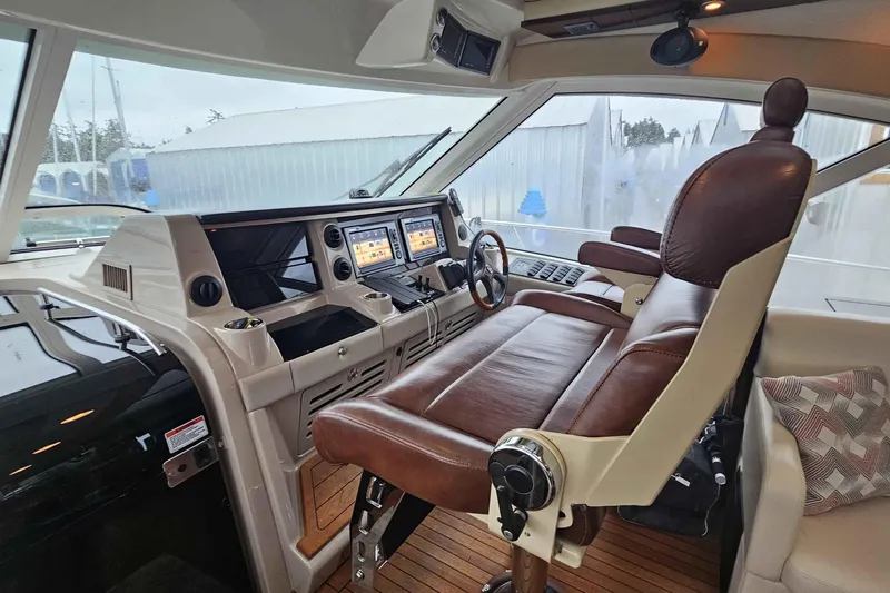 Yacht Photos Pics Luxurious helm of 2007 Sea Ray 60 Sundancer with leather seating and advanced controls.