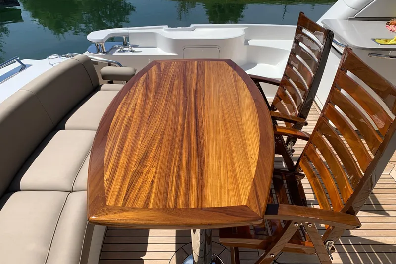  Yacht Photos Pics Luxurious 2007 Sea Ray 60 Sundancer yacht deck with elegant wooden table and chairs.