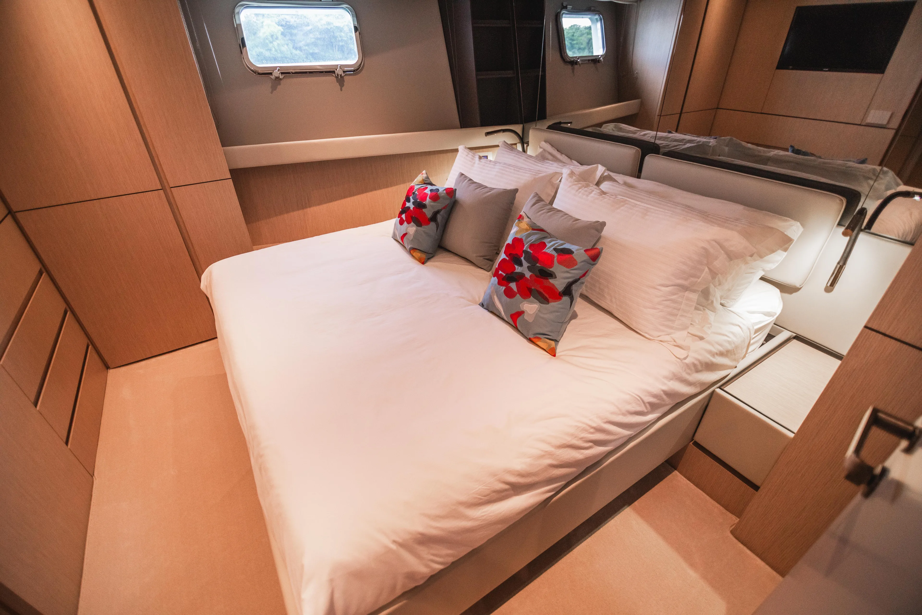  Yacht Photos Pics Luxurious cabin interior of 2023 Bluegame BGX60 yacht with elegant bedding and modern design.