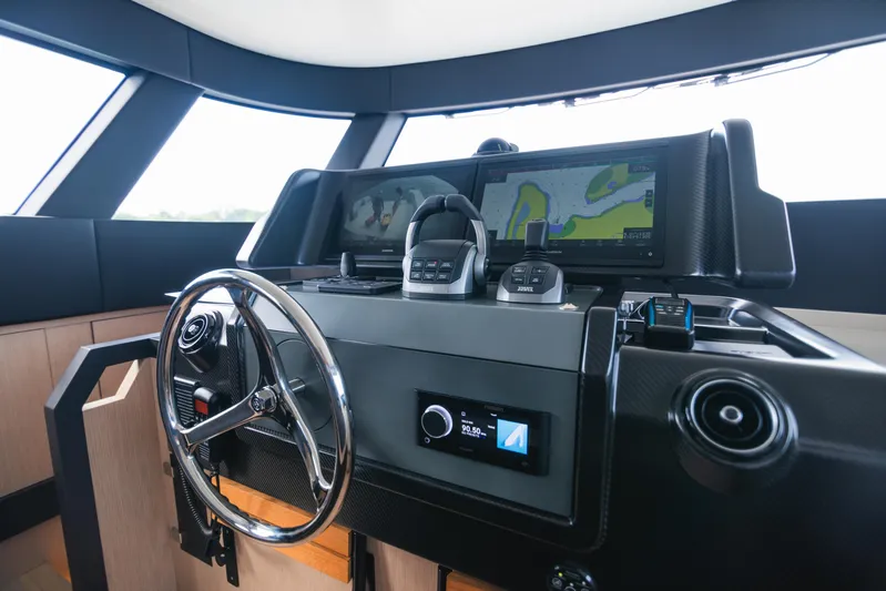  Yacht Photos Pics 2023 Bluegame BGX60 yacht helm with advanced navigation systems and sleek steering wheel.