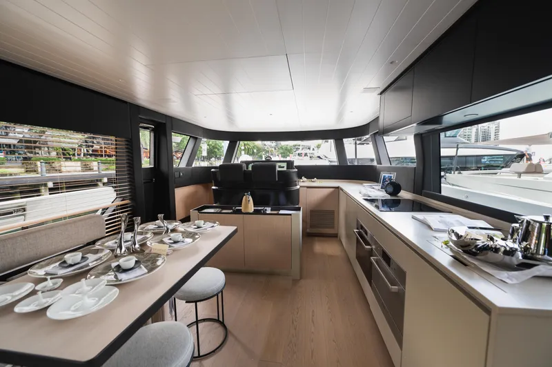  Yacht Photos Pics Luxurious interior of 2023 Bluegame BGX60 yacht with modern dining and kitchen area.