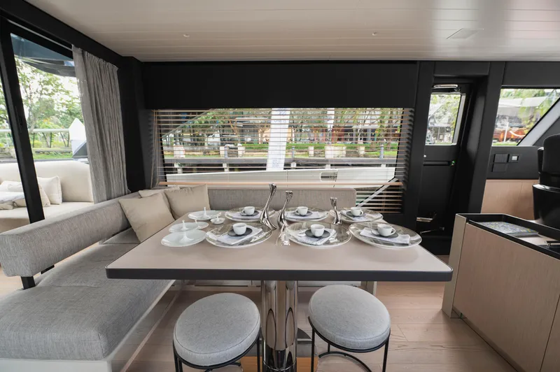  Yacht Photos Pics Luxurious interior of 2023 Bluegame BGX60 yacht with elegant dining setup.