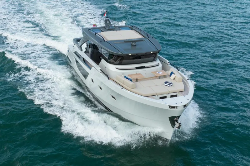  Yacht Photos Pics 2023 Bluegame BGX60 yacht cruising on open water, showcasing sleek design and luxury features.