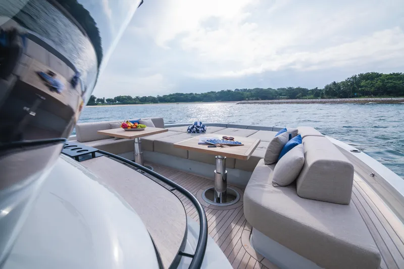  Yacht Photos Pics Luxurious 2023 Bluegame BGX60 yacht deck with elegant seating and scenic water view.