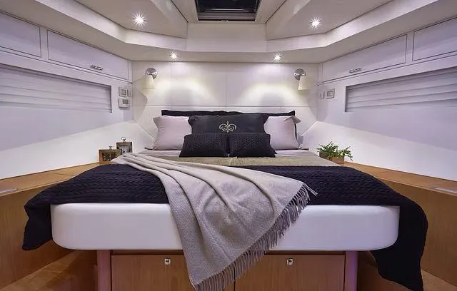  Yacht Photos Pics Luxurious cabin interior of 2026 Schaefer 25M yacht with elegant bedding and ambient lighting.