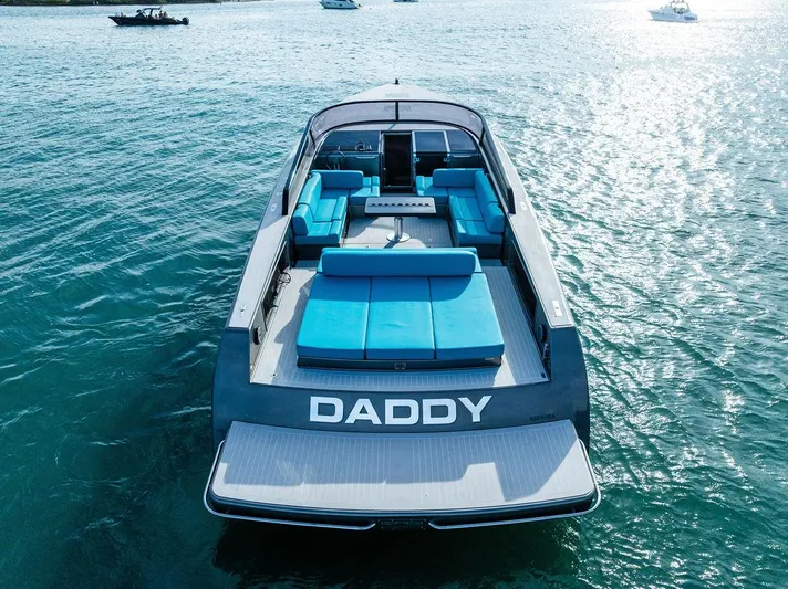 Daddy Yacht Photos Pics VanDutch 55 yacht, 2015 model, with blue seating, named "DADDY," on calm water.