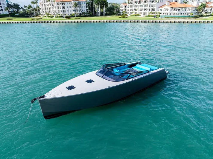 Daddy Yacht Photos Pics VanDutch 55 yacht, 2015 model, floating on turquoise water near luxury waterfront buildings.