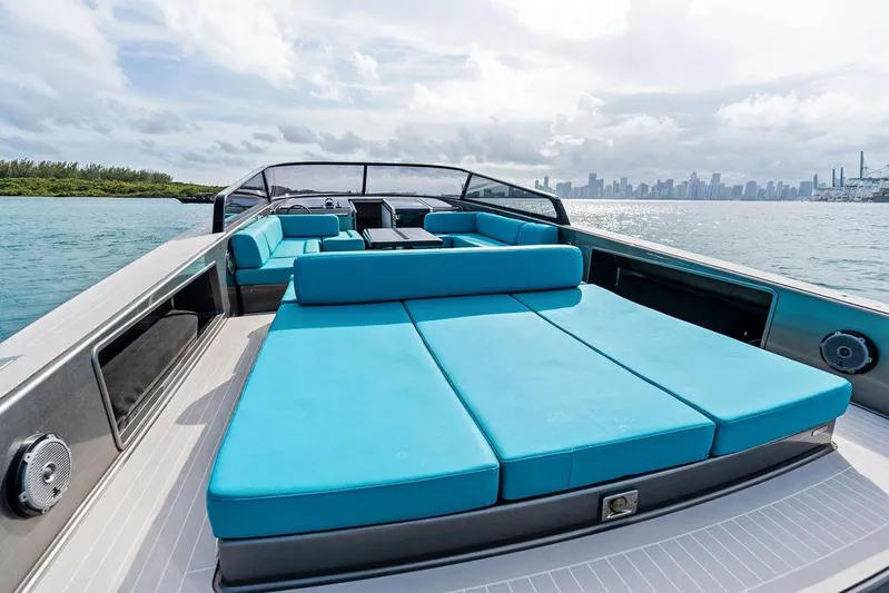 Daddy Yacht Photos Pics Luxurious 2015 VanDutch 55 yacht with spacious turquoise seating, cruising near a city skyline.